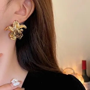 Statement gold orchid flower stud earrings for women with vintage aesthetic design