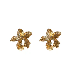 Vintage-style gold irregular flower stud earrings with a textured crinkled finish.