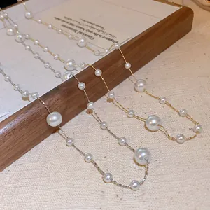 Detailed macro view of French retro irregular pearl necklaces in gold and silver finish