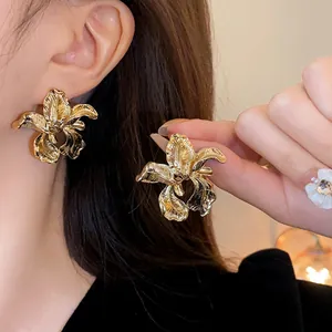 Vintage gold irregular flower stud earrings with detailed metallic petal texture design