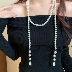 Exquisite detail view of a multi-layer vintage pearl necklace with teardrop-shaped pendants