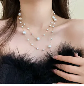 Elegant close-up view of a double-layered necklace featuring irregular pearls on a model