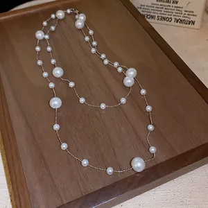 Elegant French vintage style layered pearl necklace with irregular beads on wooden tray
