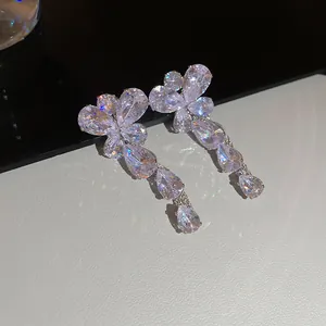 Detailed macro view of sparkling crystal flower drop earrings with elegant water-drop tassels