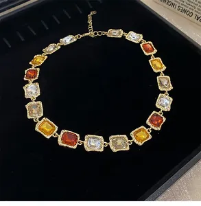 Detailed view of vintage multi-colored gemstone necklace with gold-toned square links
