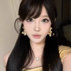 Elegant golden floral earrings worn by model for a sophisticated French jewelry look