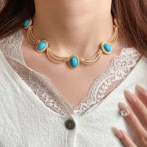 Close-up detail of vintage palace style gold necklace with oval turquoise stones