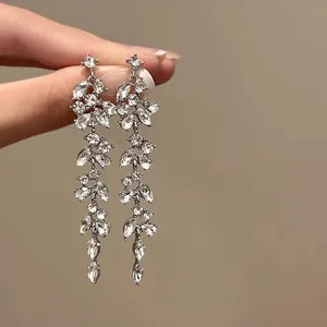 Detailed view of elegant silver flower tassel earrings featuring sparkling clear crystals