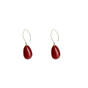 Elegant red teardrop dangle earrings with gold hooks in a classic French retro style.