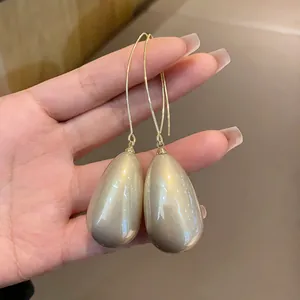 Detailed view of French vintage water-drop pearl earrings with elegant gold hooks