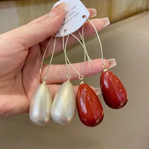 Detail shot of French vintage waterdrop pearl earrings with elegant gold hooks