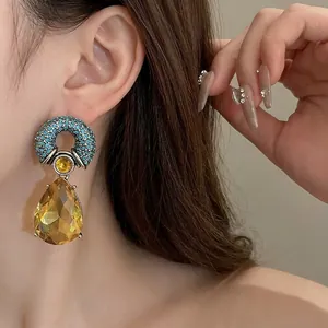 Elegant vintage-style drop earrings with blue rhinestones and yellow crystal pendant