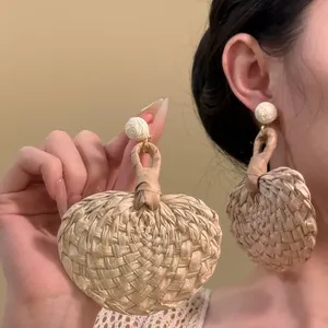 Woven rattan earrings with white flower studs and geometric heart pendants for vacation