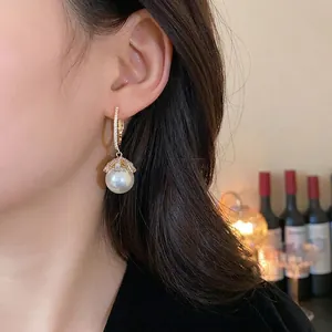 Elegant silver needle pearl drop earrings featuring a sparkling diamond floral design