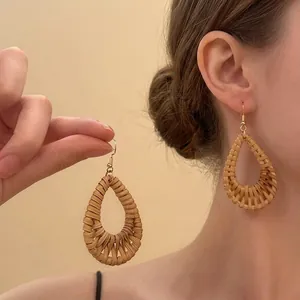 Handmade woven rattan teardrop earrings for summer beach vacation style.
