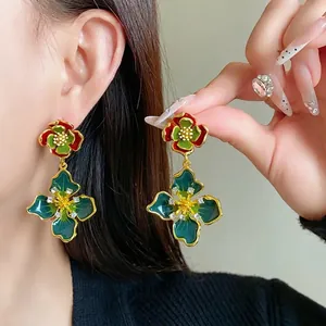 Vintage French style floral drop earrings featuring enamel petals and sparkling rhinestones.