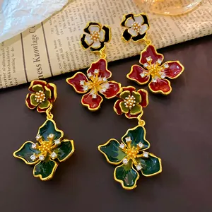 Close-up of vintage French style enamel floral earrings with sparkling crystal centers