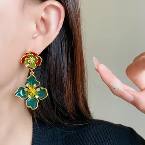 Close-up of vintage French style enamel flower earrings with sparkling rhinestones