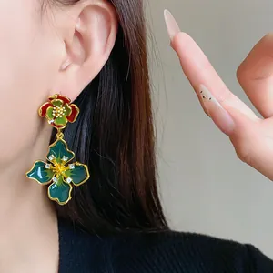 Detail view of vintage French style enamel floral earrings with rhinestone accents.