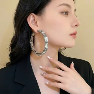 Exaggerated large hoop earrings with sparkling rectangular crystals and silver needles