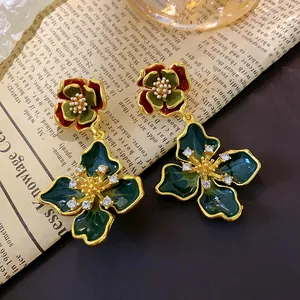 Macro view of vintage French style enamel flower earrings with sparkling rhinestones
