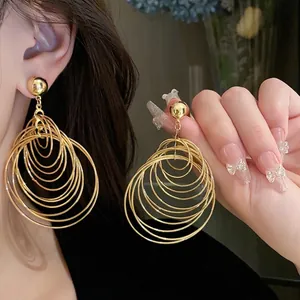 Fashionable gold multi-layered circular hoop earrings for women in a modern metal style.