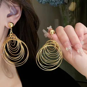 Detailed macro shot of gold layered hoop earrings with a shiny metallic finish