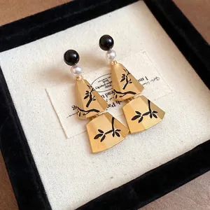 Vintage Chinese style pearl tassel earrings with gold fan shapes and black floral patterns