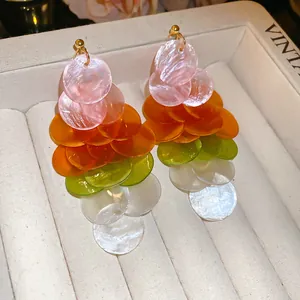 Holiday style dangling earrings with multi-colored resin discs in pink, orange and green.