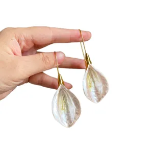 Elegant pearlescent white floral petal pendant earrings with gold hooks in retro style