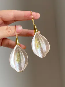 Close-up view of the elegant gold plated petal drop earrings with pearlescent finish