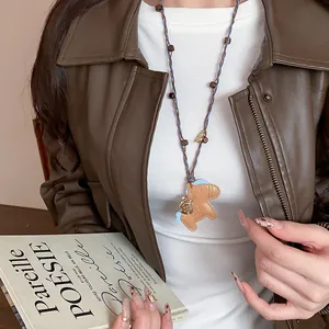 Close-up detail of a charming leather horse pendant necklace with natural wooden beads