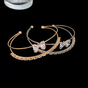 Macro view of luxury double-row bracelets featuring zircon butterfly charms and stones