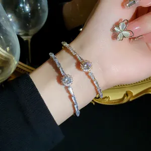 Macro detail of sparkling gold zircon bracelets and an elegant butterfly ring on a wrist