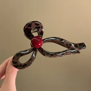 Korean style leopard print wave hair claw clip with a chic red accent bead detail