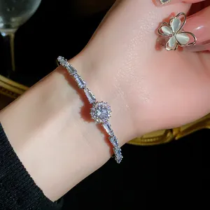 Detailed close-up of sparkling silver zircon bracelet with butterfly ring accessory