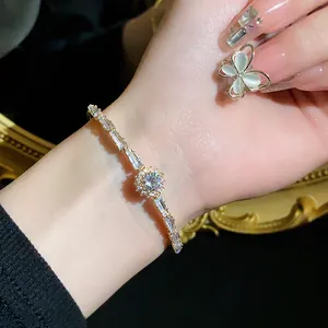 Close-up of gold-tone zircon bracelet with sparkling crystals on a woman's wrist