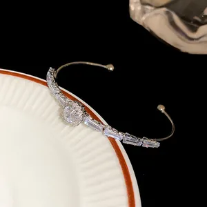 Detailed view of luxury silver cuff bracelet featuring sparkling round and baguette zircons