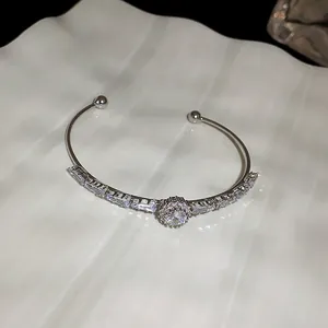 Detailed view of an elegant silver cuff bracelet with sparkling cubic zirconia stones