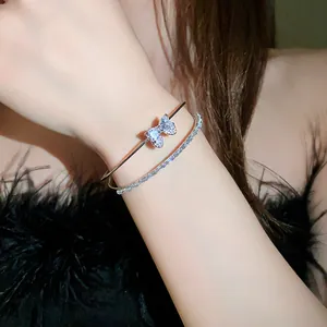 Close-up shot of a sparkling zircon bow double-row bracelet on an elegant female wrist