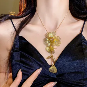Detailed close-up of a luxury gold hollow-out flower necklace with sparkling rhinestones