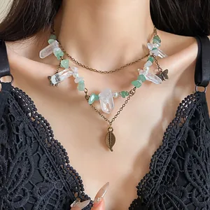 Vintage layered necklace with crystal points, green stones, and butterfly leaf charms