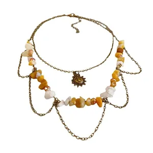 Retro boho layered necklace featuring irregular yellow stones and a sun pendant charm