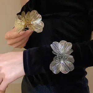 Detailed view of hollow flower bracelets with rhinestones on a black velvet background