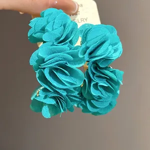 Elegant teal chiffon fabric flower C-shaped stud earrings with a beach vacation aesthetic