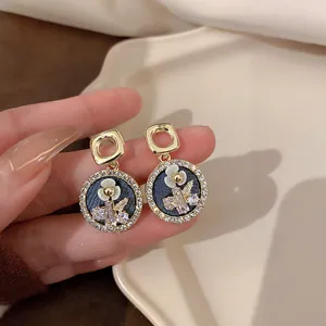 Detailed view of French vintage floral stud earrings with sparkling crystal accents