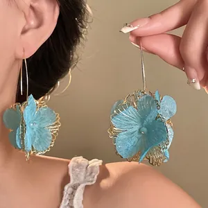 Elegant light blue layered fabric flower drop earrings with golden hollow vintage design.