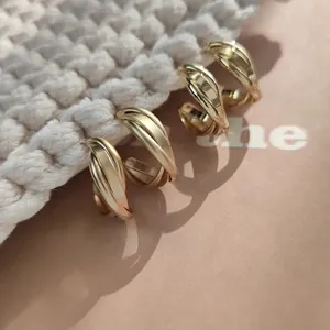Elegant gold-toned twisted hoop earrings featuring mixed matte and shiny finishes