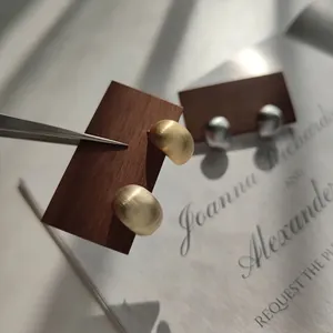 Minimalist geometric dome stud earrings featuring premium matte gold and silver metal finishes