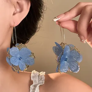 Elegant vintage hollow blue flower drop earrings with gold lace and central blue crystal